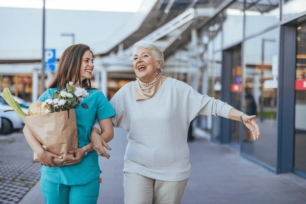 cheerful-caregiver-helps-joyful-elderly-600nw-2540396203